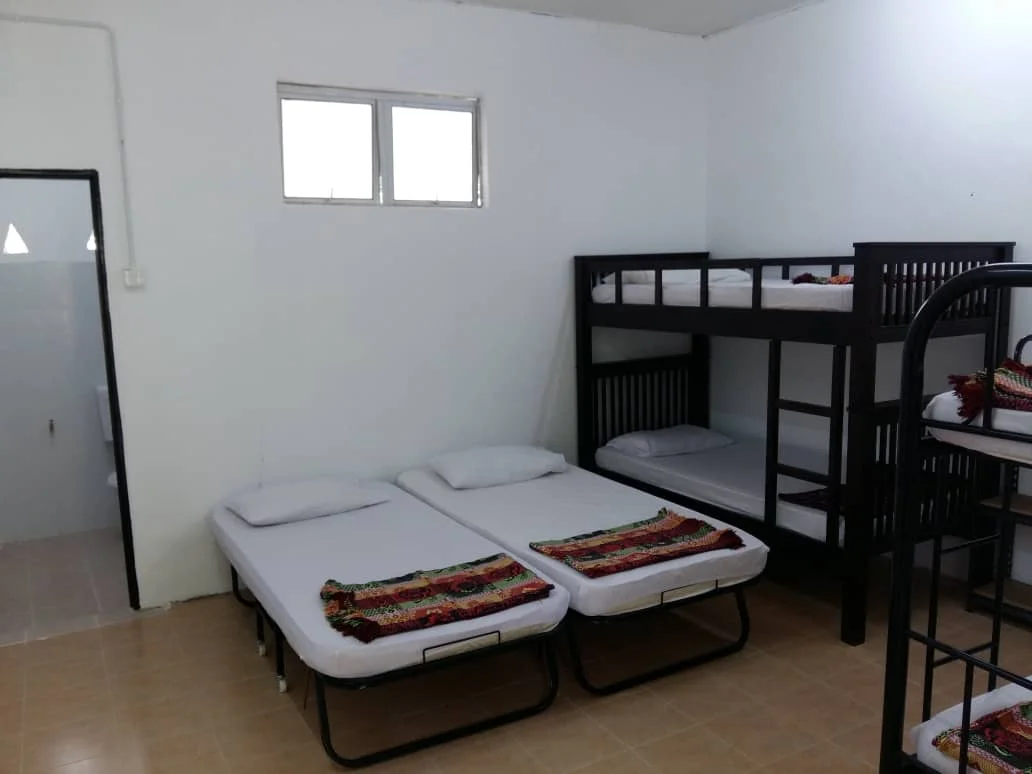 Dorm room with single beds and double-decker bunks